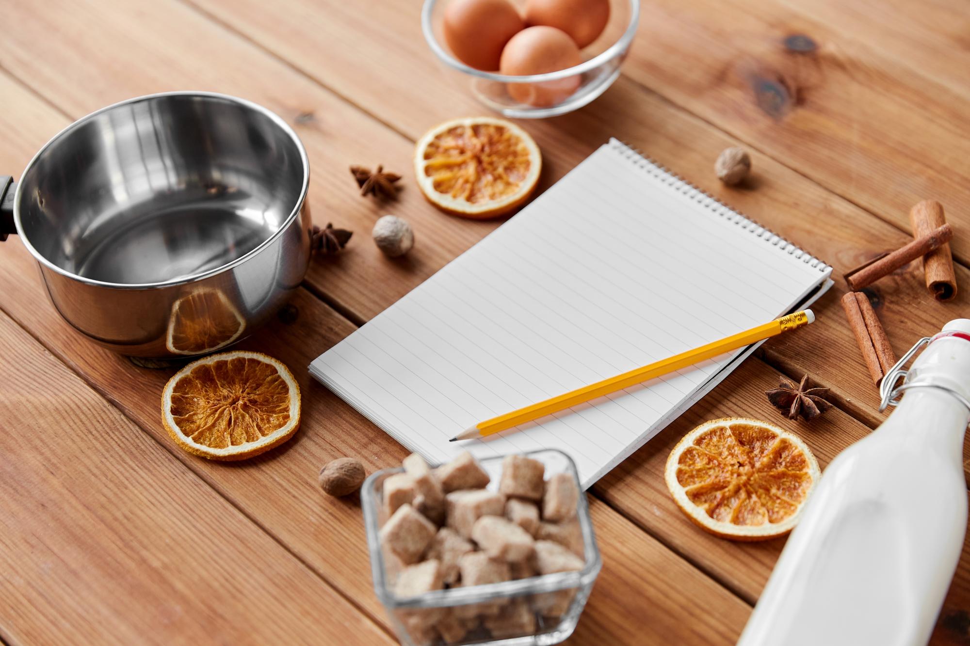Open notebook with recipe notes and cost table